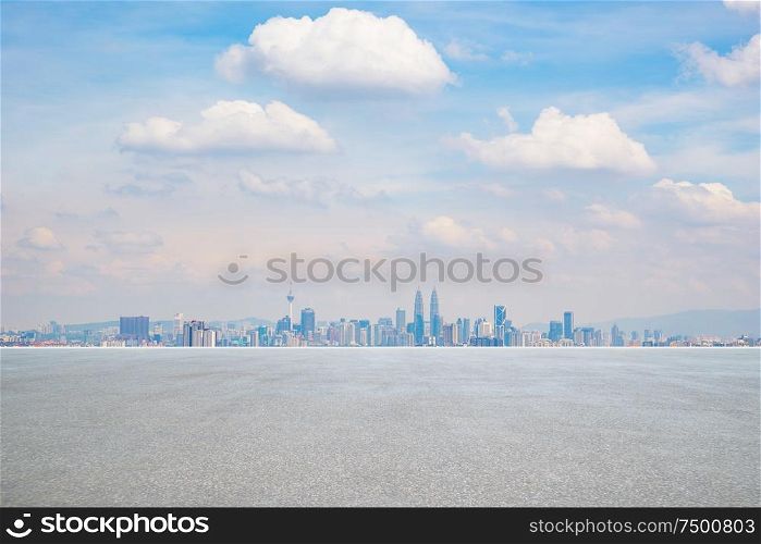 Panoramic city skyline with empty concrete floor .
