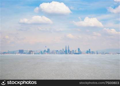 Panoramic city skyline with empty concrete floor .