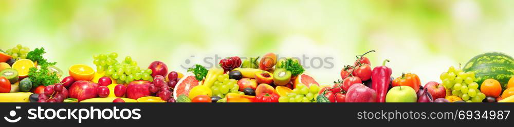 Panoramic collection fresh fruits and vegetables for skinali on blur green background. Copy space
