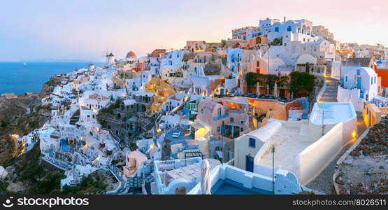 Panoramic famous view, Old Town of Oia or Ia on the island Santorini, white houses and windmills at dawn, Greece