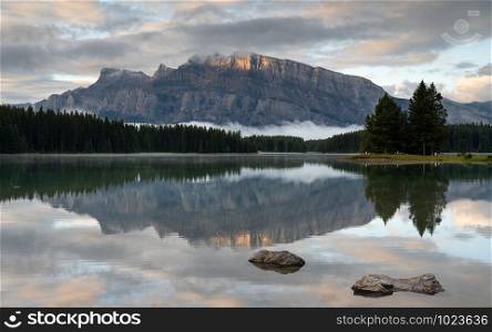 Panoramic image of Mount Rundle reflecting in Two Jack Lake with early morning mood, Banff National Park, Alberta, Canada