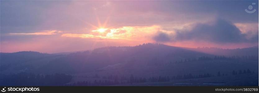 Panoramic image of rising sun in Carpathian mountains, Ukraine