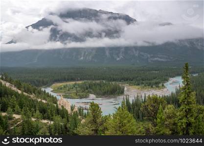 Panoramic image of the Hoodoos close to Banff with the Bow river and the Mount Rundle under clowds in the background, Banff National Park, Alberta, Canada