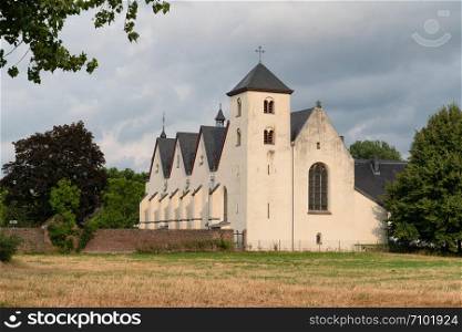 Panoramic image of the old parish church of Cologne Duennwald on a cloudy day, Germany