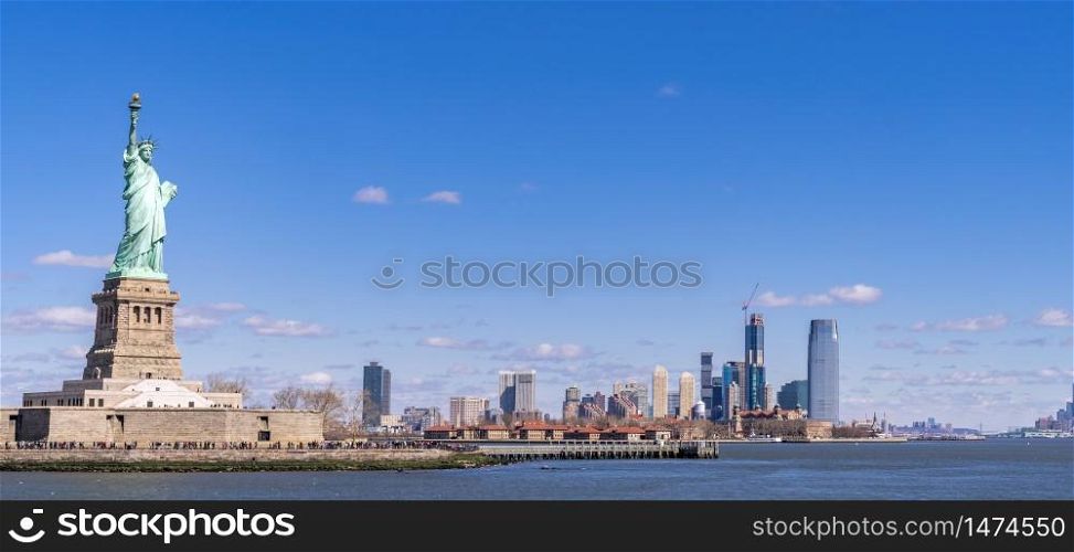 Panoramic landscape of Statue of Liberty with Manhattan downtown Skylines skyscraper building in background, NYC, New York State USA. New York Landmark Travel Destination and cityscape concept.