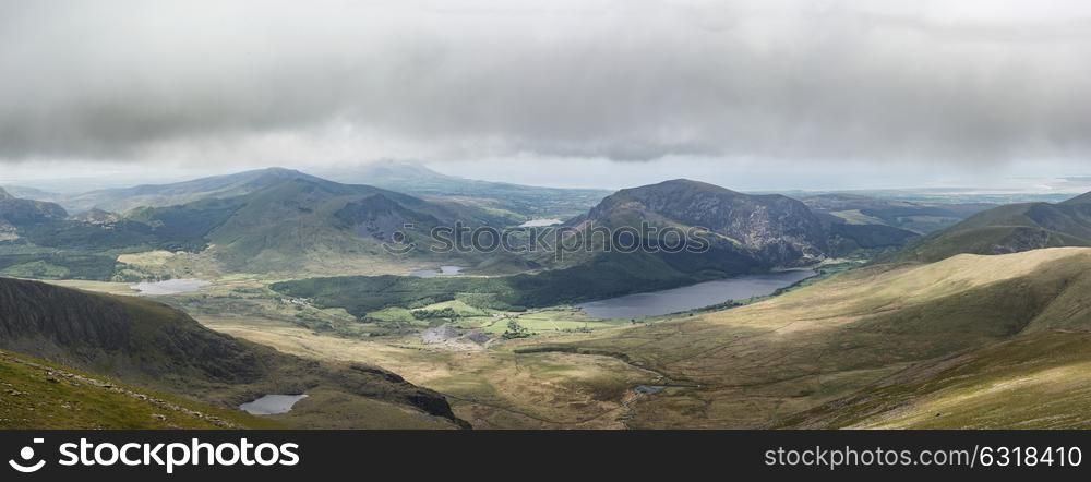 Panoramic landscape view of Llyn Cwellyn and Moel Cynghorion in Snowdonia shrouded in fog and low cloud