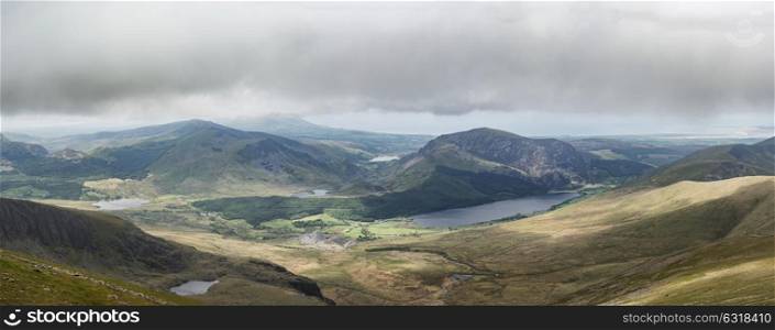 Panoramic landscape view of Llyn Cwellyn and Moel Cynghorion in Snowdonia shrouded in fog and low cloud