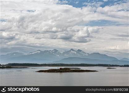 Panoramic mountain view with a house in an island in the fjord in Molde, Norway. Mountain view with some islands in the fjord in Molde, Norway