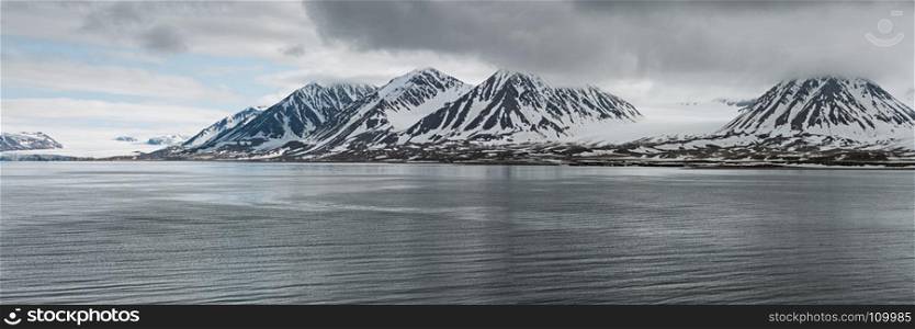 Panoramic mountains in Svalbard islands in a cloudy day, Norway. Mountains in Svalbard islands, Norway