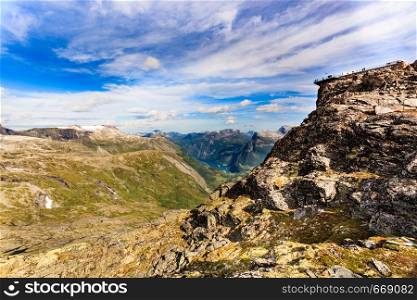 Panoramic mountains landscape with Geirangerfjord from Dalsnibba area. Geiranger Skywalk viewing platform on mountain in distance. Norway.. Mountains landscape with Dalsnibba viewpoint, Norway