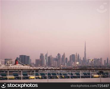 Panoramic photo of Dubai in the evening. View from a cruise liner. Concept of leisure and travel. Panoramic photo of Dubai in the evening