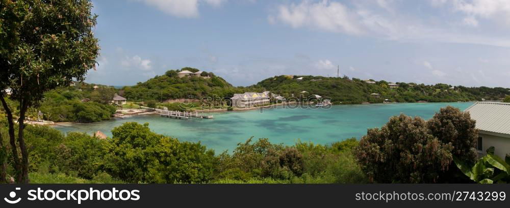 panoramic picture of Antigua Long Bay, gorgeous view surrounded by tropical nature and some typical houses