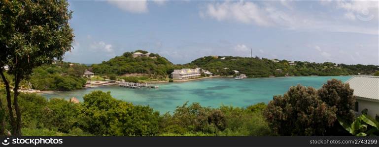 panoramic picture of Antigua Long Bay, gorgeous view surrounded by tropical nature and some typical houses