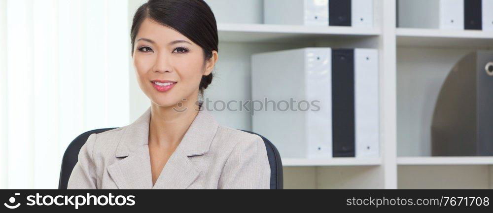 Panoramic portrait of a successful young Asian Chinese woman or business woman in office panorama web banner header