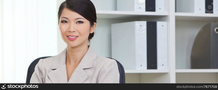 Panoramic portrait of a successful young Asian Chinese woman or business woman in office panorama web banner header