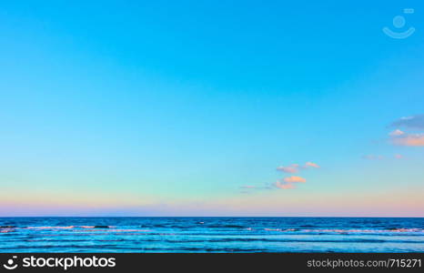 Panoramic seascape with sea horizon and almost clear blue sky - Background with large space for text