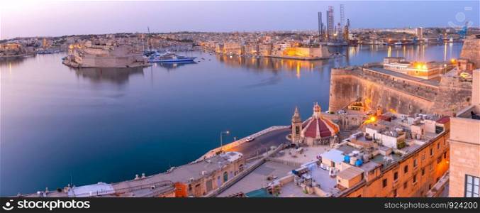 Panoramic skyline view of ancient defences of Valletta and the Grand Harbor with ships and Three cities, three fortified cities of Birgu, Senglea and Cospicua, at dawn, Valletta, Malta.. Valletta and the Grand Harbor at dawn. Malta.