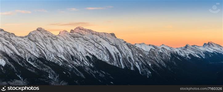 Panoramic sunset skyline of snow capped Canadian Rocky mountains at Banff National Park in Alberta, Canada. View from Banff Gondola Sulphur Moutain.