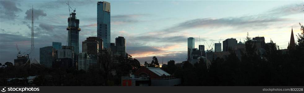 panoramic sunset view of Melbourne city central CBD skyscraper buildings by the Yarra river, Central Victoria, Australia