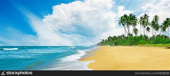 Panoramic tropical seascape with blue sky and yellow sand. Sea background