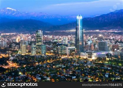 Panoramic view at night of Santiago de Chile with The Andes Mountain Range in the back