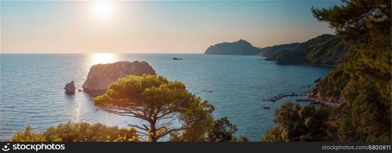 Panoramic view from Sinarades village to Ermones village at sunset, rocky coast and blue sea. Corfu, Greece