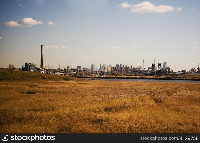 Panoramic view of a field with a city in the background