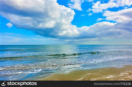 Panoramic view of a sandy beach, Mediterranean sea and white clouds in the sky - Seascape. Cyprus