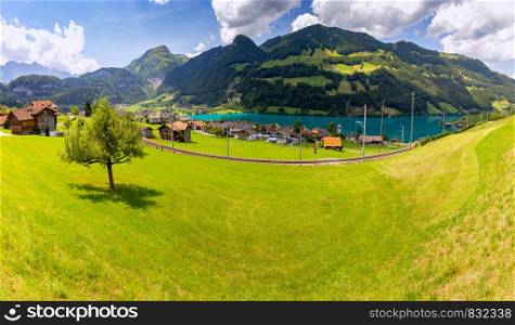 Panoramic view of a traditional medieval alpine village on a sunny day. Lungern Switzerland.. Lungern. Panorama. Old medieval village in the swiss alps.