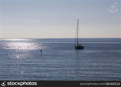 Panoramic view of an Italian seaside landscape on a sunny day with a boat on the horizon