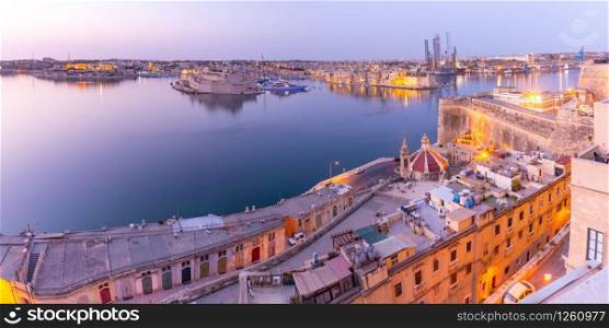 Panoramic view of ancient defences of Valletta, Grand Harbor and Three fortified cities of Birgu, Senglea and Cospicua, at sunrise, Valletta, Malta.. Valletta and the Grand Harbor at dawn. Malta.