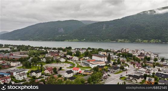 Panoramic view of Andalsnes city in Norway with mountains on background under a cloudy sky. Panoramic view of Andalsnes city in Norway