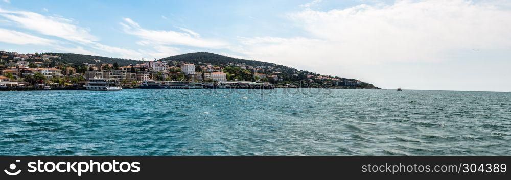 Panoramic View of Buyukada (big island) from sea ferry.The island is one of four islands named Princes Islands in the Sea of Marmara, near Istanbul, Turkey.20 May 2017.. View of Buyukada (big island) from sea ferry,Istanbul,Turkey