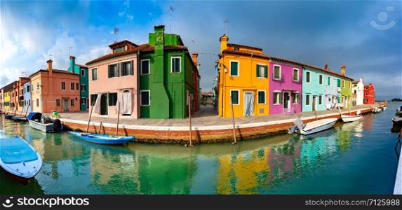 Panoramic view of Canal with colorful houses and boats on the famous venetian island Burano, Venice, Italy. Colorful houses in Burano, Venice