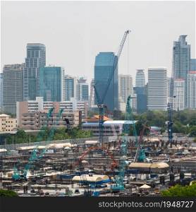 Panoramic view of cityscape and construction site in metropolis . Real estate development in downtown business district .. Panoramic view of cityscape and construction site in metropolis