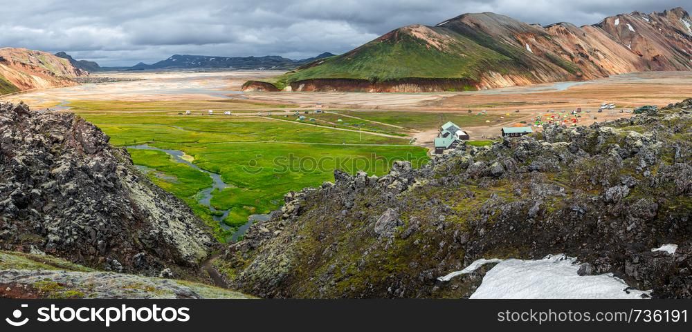 Panoramic view of colorful volcanic Landmannalaugar region and camping site in Iceland, summer time, dramatic scene