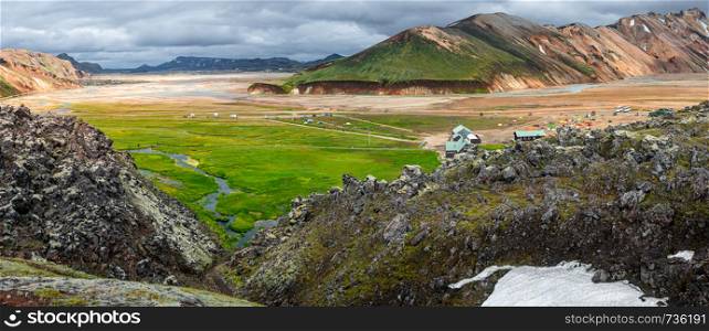 Panoramic view of colorful volcanic Landmannalaugar region and camping site in Iceland, summer time, dramatic scene