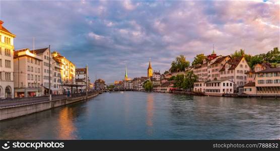 Panoramic view of famous Fraumunster and Church of St Peter and river Limmat at sunset in Old Town of Zurich, the largest city in Switzerland. Zurich, the largest city in Switzerland