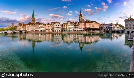 Panoramic view of famous Fraumunster, St Peter church and river Limmat at sunrise in Old Town of Zurich, the largest city in Switzerland. Zurich, the largest city in Switzerland