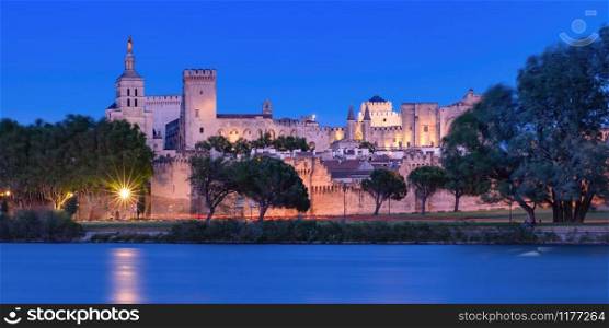 Panoramic view of famous medieval Saint Benezet bridge and Palace of the Popes during evening blue hour, Avignon, southern France. Famous Avignon Bridge, France