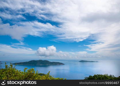 Panoramic view of Felicite and Marianne island from the Nid D"Aigles top hill point, with blue sky reflected on the sea. La Digue Island, Seychelles