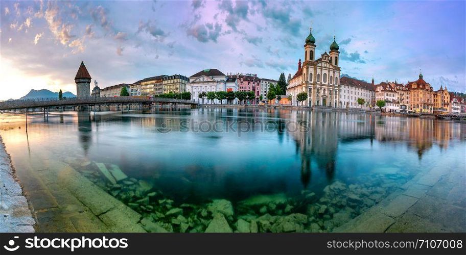 Panoramic view of Jesuit Church and Water Tower, Wasserturm along the river Reuss at sunrise in Old Town of Lucerne, Switzerland. Lucerne at sunrise, Switzerland