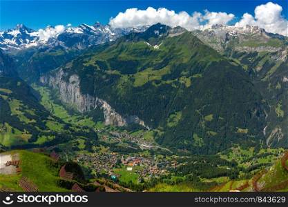 Panoramic view of Lauterbrunnen valley and Swiss Alps from the summit of mountain Mannlichen, Switzerland.. Mountain village Wengen, Switzerland