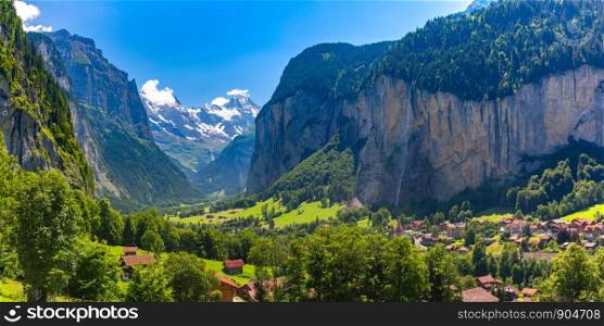Panoramic view of Lauterbrunnen valley, village of Lauterbrunnen, the Staubbach Fall, and the Lauterbrunnen Wall in Swiss Alps, Switzerland.. Mountain village Lauterbrunnen, Switzerland