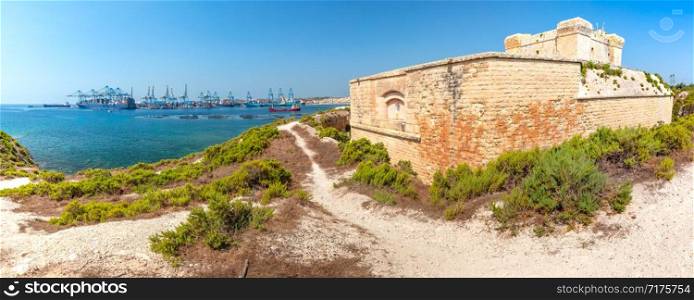Panoramic view of Malta Freeport and Fort San Lucian near Marsaxlokk on a sunny day, Malta. Fort San Lucian in Marsaxlokk, Malta