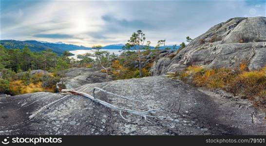 Panoramic view of norwegian rocks and distant fjord