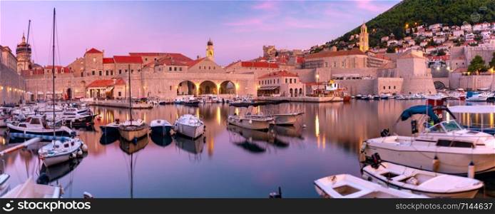 Panoramic view of Old Harbour with boats and Old Town of Dubrovnik at sunset, Croatia. Old Harbor of Dubrovnik, Croatia