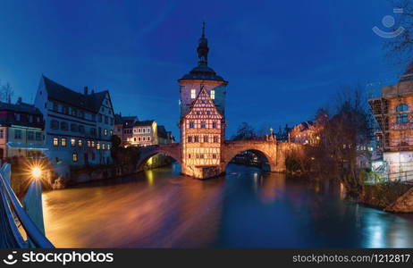 Panoramic view of Old town hall or Altes Rathaus with two bridges over the Regnitz river at night in Bamberg, Bavaria, Upper Franconia, Germany. Old Town of Bamberg, Bavaria, Germany