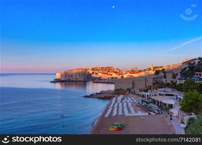 Panoramic view of Old Town with Banje Beach, Old Harbour and Fort St Ivana at sunset in Dubrovnik, Croatia. Old Harbor of Dubrovnik, Croatia