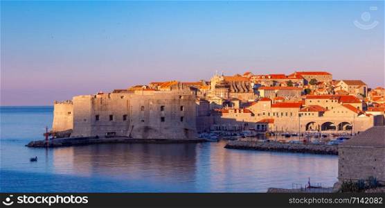 Panoramic view of Old Town with Old Harbour and Fort St Ivana at sunset in Dubrovnik, Croatia. Old Harbor of Dubrovnik, Croatia